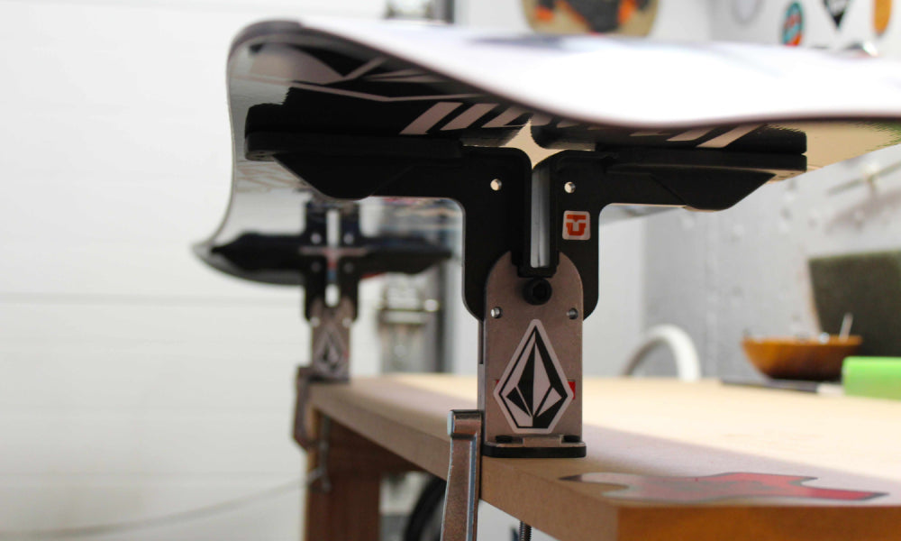 Snowboard being tuned in workshop